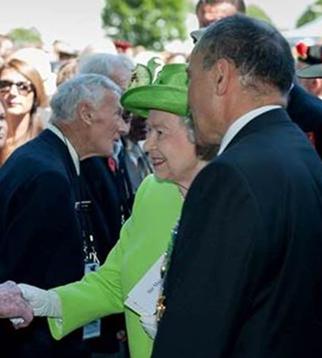 Pen talks with Prince Philip just after being introduced to Her Majesty The Queen